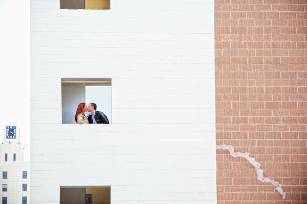 happy couple kissing in window - photo by Southern California wedding photographers Callaway Gable